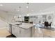 Open-concept kitchen overlooking the living area, features an island, and stainless appliances at 629 Newlyn Dr, Raleigh, NC 27606