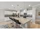 Spacious kitchen with stainless steel appliances, an island with seating, and white cabinets at 629 Newlyn Dr, Raleigh, NC 27606