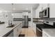 Modern kitchen features stainless steel appliances, white cabinets, and a countertop island at 629 Newlyn Dr, Raleigh, NC 27606