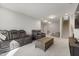 Spacious living room with comfortable seating, carpeted floors, and stairs to the upper level at 629 Newlyn Dr, Raleigh, NC 27606