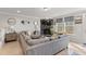 Cozy living room featuring a stone fireplace, large sectional sofa, and abundant natural light at 629 Newlyn Dr, Raleigh, NC 27606