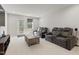 Cozy living room features comfortable seating, a center table, carpeted floors, and natural light at 629 Newlyn Dr, Raleigh, NC 27606