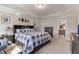 Primary bedroom featuring tray ceilings, large bed, and a view of the Primary bathroom at 629 Newlyn Dr, Raleigh, NC 27606