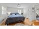 Bright bedroom with hardwood floors, a plush bed, and a stylish chandelier at 808 Ravenwood Dr, Raleigh, NC 27606