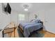 Bright bedroom with desk area, hardwood floors, closet, and a comfortable bed at 808 Ravenwood Dr, Raleigh, NC 27606