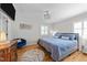 Cozy bedroom featuring hardwood floors, a blue accent chair, and a modern chandelier at 808 Ravenwood Dr, Raleigh, NC 27606