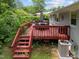 Back deck with outdoor furniture, a grill, and stairs leading to the backyard at 808 Ravenwood Dr, Raleigh, NC 27606