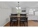 An inviting dining area featuring a classic table and chairs under a chandelier at 808 Ravenwood Dr, Raleigh, NC 27606