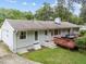 Backyard featuring a well-kept lawn, a deck, and a home with white siding at 808 Ravenwood Dr, Raleigh, NC 27606