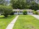 Charming single-story home with a well-manicured lawn, sidewalk, driveway, and lush landscaping at 808 Ravenwood Dr, Raleigh, NC 27606