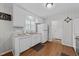 Well-lit kitchen with white cabinetry, wood floors, and modern appliances at 808 Ravenwood Dr, Raleigh, NC 27606