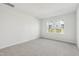 Spacious bedroom featuring neutral carpet, white walls, and a large window at 809 Hyperion Aly, Wake Forest, NC 27587
