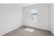 Cozy bedroom with neutral carpet and a bright window providing natural light at 809 Hyperion Aly, Wake Forest, NC 27587