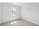 This bedroom features neutral carpet, white walls, and a window letting in plenty of natural light at 809 Hyperion Aly, Wake Forest, NC 27587
