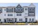 Attractive two-story townhomes featuring a mix of white and gray siding and dark window frames at 809 Hyperion Aly, Wake Forest, NC 27587
