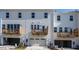 Townhomes with white siding, private balconies, and attached garages at 809 Hyperion Aly, Wake Forest, NC 27587