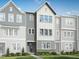 New construction townhome with modern farmhouse facade, landscaped front yard, and stone accents at 809 Hyperion Aly, Wake Forest, NC 27587