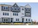 Charming townhomes with a combination of white and gray exterior, complemented by dark accents at 809 Hyperion Aly, Wake Forest, NC 27587