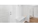 Mudroom featuring a bench and storage cubbies next to the front door and a bathroom with glass enclosed shower at 809 Hyperion Aly, Wake Forest, NC 27587