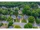 A high aerial view of a residential neighborhood with tree lined streets and well maintained homes and yards at 8913 Walking Stick Trl, Raleigh, NC 27615