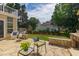 A beautiful backyard with a stone patio, well-maintained lawn, and lush landscaping at 8913 Walking Stick Trl, Raleigh, NC 27615