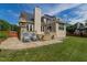 Expansive backyard with stone patio, outdoor fireplace, and access to an upper-level deck at 8913 Walking Stick Trl, Raleigh, NC 27615