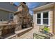 Outdoor stone fireplace with patio seating, perfect for enjoying the backyard scenery at 8913 Walking Stick Trl, Raleigh, NC 27615
