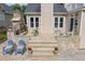 Backyard with a stone patio, outdoor fireplace, and seating area for relaxation and entertainment at 8913 Walking Stick Trl, Raleigh, NC 27615
