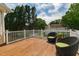 Balcony with a wood deck, white railings, and two comfortable outdoor chairs at 8913 Walking Stick Trl, Raleigh, NC 27615