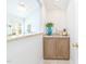 Charming powder room with granite countertops, wood cabinets and a decorative vase at 8913 Walking Stick Trl, Raleigh, NC 27615