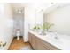 Well-lit bathroom with neutral tones, patterned floors, a large mirror and a decorative plant at 8913 Walking Stick Trl, Raleigh, NC 27615