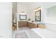 Bright bathroom boasts dual vanities, soaking tub, and shower with a harmonious, neutral color palette at 8913 Walking Stick Trl, Raleigh, NC 27615