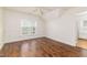 Bright bedroom with hardwood floors, wainscotting, and view to the yard through the window at 8913 Walking Stick Trl, Raleigh, NC 27615