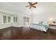 Sun-filled bedroom featuring hardwood floors, a bay window, and a sliding glass door to a private balcony at 8913 Walking Stick Trl, Raleigh, NC 27615