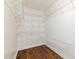 Walk-in closet with white wire shelving and hardwood floors at 8913 Walking Stick Trl, Raleigh, NC 27615