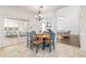 Bright dining area with wooden table and access to the sunroom and the living room at 8913 Walking Stick Trl, Raleigh, NC 27615