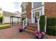Charming front entry with brick walkway, front porch and swing bench at 8913 Walking Stick Trl, Raleigh, NC 27615