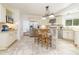 Spacious eat-in kitchen with white cabinets, tile backsplash, stainless steel appliances, and breakfast bar seating at 8913 Walking Stick Trl, Raleigh, NC 27615