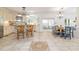 Open kitchen with a decorative tile floor design and a breakfast bar with wooden stools at 8913 Walking Stick Trl, Raleigh, NC 27615