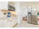 Updated kitchen featuring white cabinets, granite countertops, stainless steel appliances, and tile flooring at 8913 Walking Stick Trl, Raleigh, NC 27615
