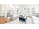 Bright and airy living room featuring hardwood floors, large windows, and a staircase at 8913 Walking Stick Trl, Raleigh, NC 27615