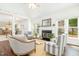 Inviting living room with a fireplace, large windows, and hardwood floors at 8913 Walking Stick Trl, Raleigh, NC 27615