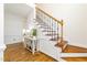Elegant staircase with hardwood steps and wrought iron railing at 8913 Walking Stick Trl, Raleigh, NC 27615
