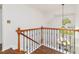 Elegant staircase with wood and black iron banister offering a view of the entryway and chandelier at 8913 Walking Stick Trl, Raleigh, NC 27615