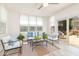 Bright sun room with white decor, multiple seating options, large windows, and a sliding glass door at 8913 Walking Stick Trl, Raleigh, NC 27615