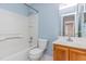 Cozy bathroom featuring a bathtub with white tile surround and a vanity with wood cabinets at 9308 Carisbrook Ct, Raleigh, NC 27615