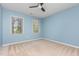 Blue bedroom with neutral carpet, a ceiling fan, and lots of natural light at 9308 Carisbrook Ct, Raleigh, NC 27615