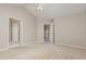 Spacious bedroom with a ceiling fan and carpet, with an open door showing the hallway at 9308 Carisbrook Ct, Raleigh, NC 27615