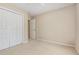 Bedroom with neutral carpet, white closet doors, and lots of natural light at 9308 Carisbrook Ct, Raleigh, NC 27615