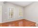 Cozy bedroom with hardwood floors and natural light from two windows at 9308 Carisbrook Ct, Raleigh, NC 27615